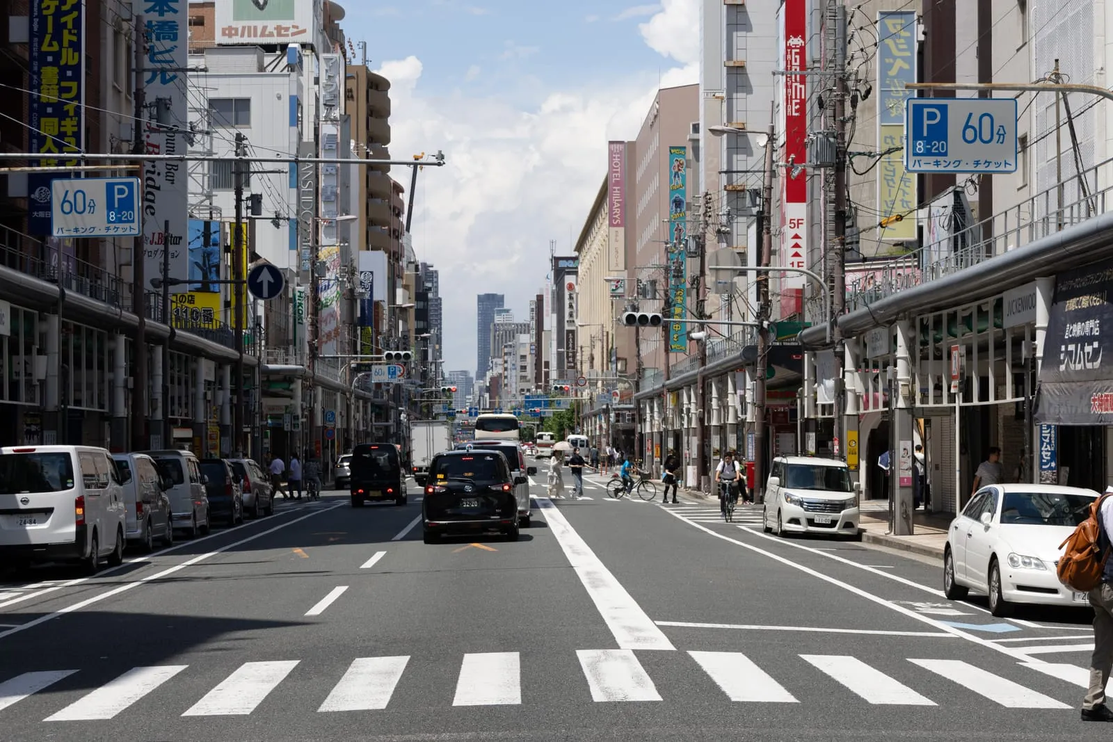 The Den Den Town streetscape in Nipponbashi, Osaka, lined with anime and electronics shops