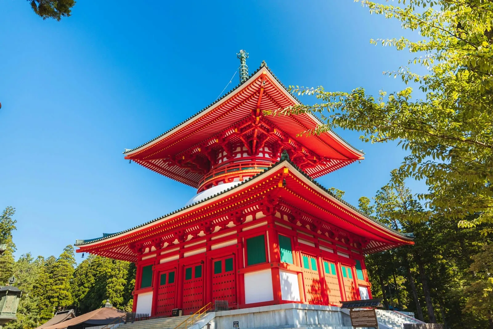 The vermilion Konpon Daitō pagoda of the Danjo Garan rising beside cedar forest at Koyasan