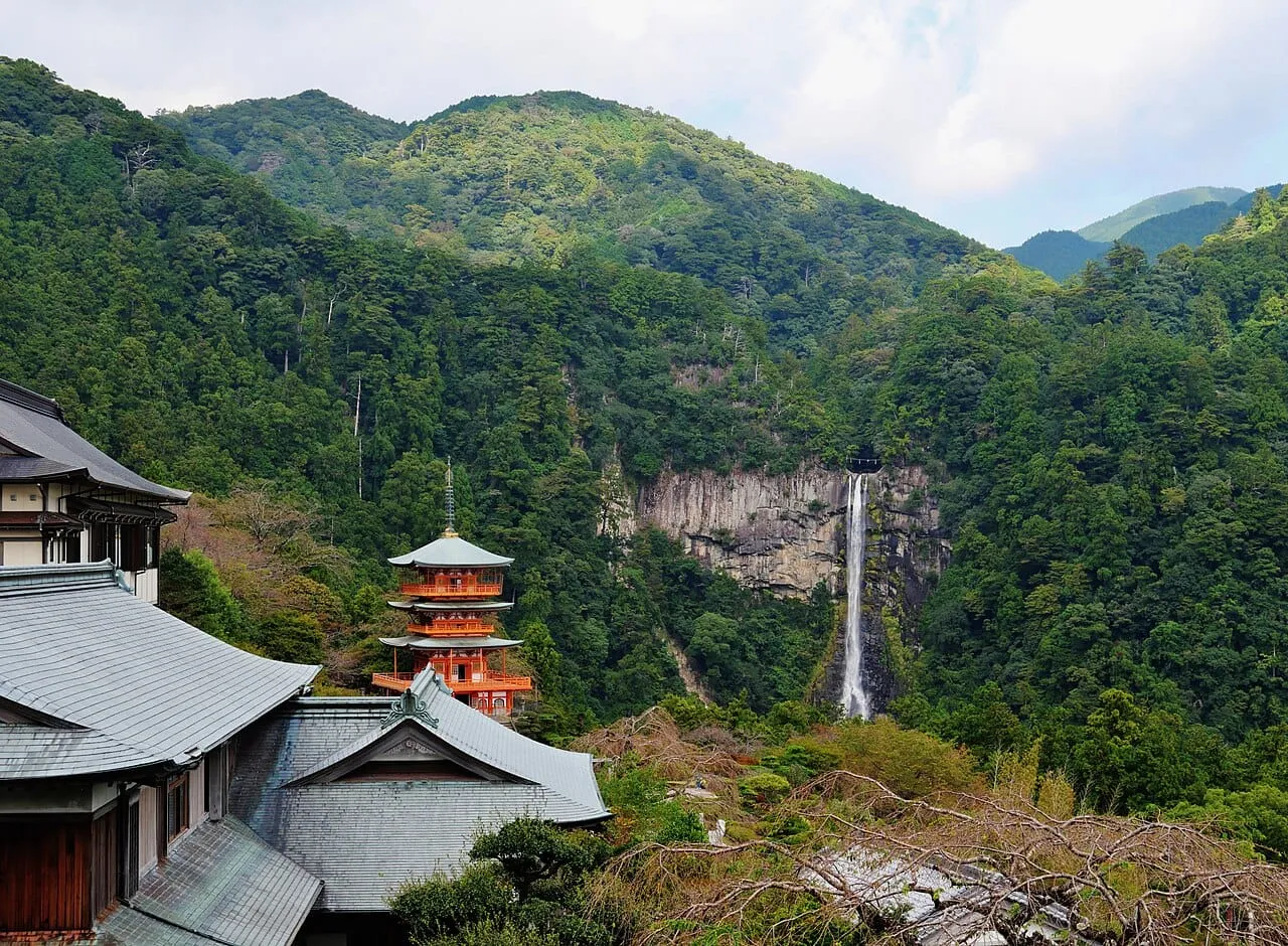 The vermilion three-storied pagoda of Seiganto-ji beside the tall Nachi Falls, Kumano Kodo, Wakayama