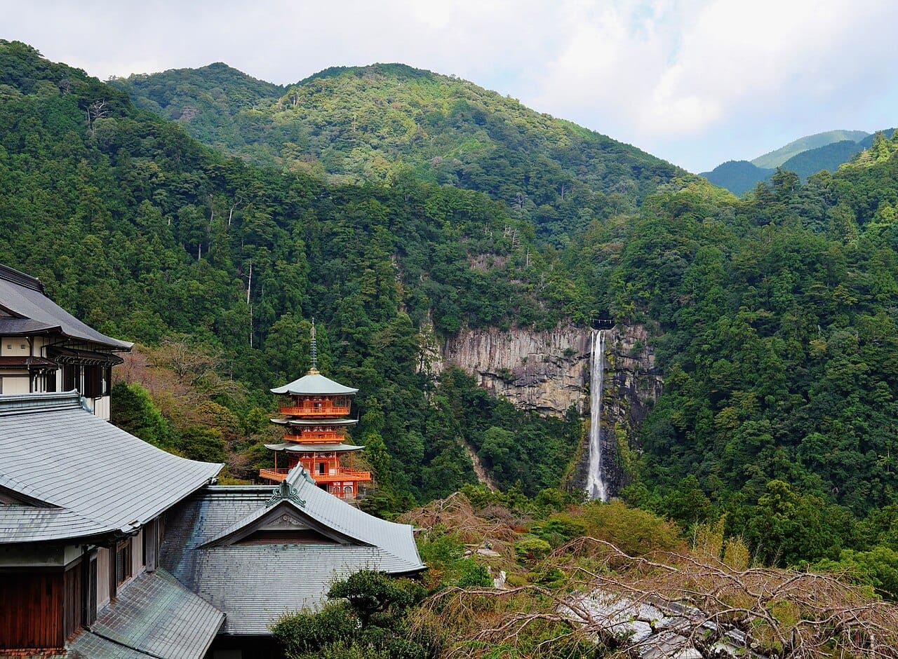 The vermilion three-storied pagoda of Seiganto-ji beside the tall Nachi Falls, Kumano Kodo, Wakayama